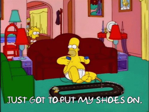 Homer Simpson in underwear playing with pocket racers: “just got to put on my shoes”
