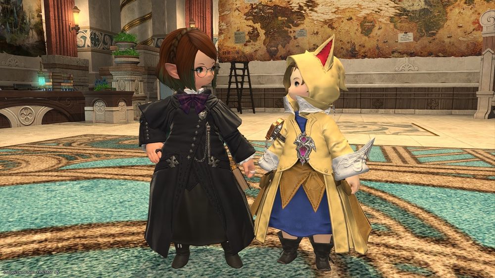 Two lalafells (dwarf race from Final Fantasy 14) standing and smiling at each other: my character, Hime, wearing a black tunic and glasses, and Krile, wearing a yellow tunic and a hoodie with cat ears