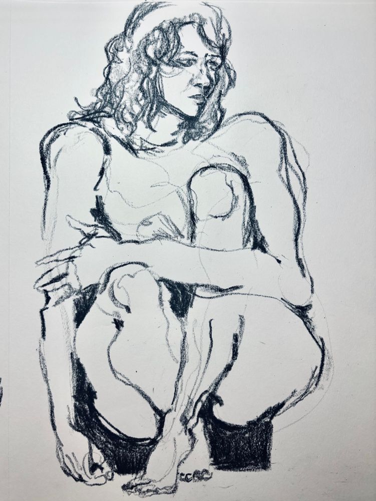 A nude figure crouching, depicted in charcoal, a pensive expression on her face