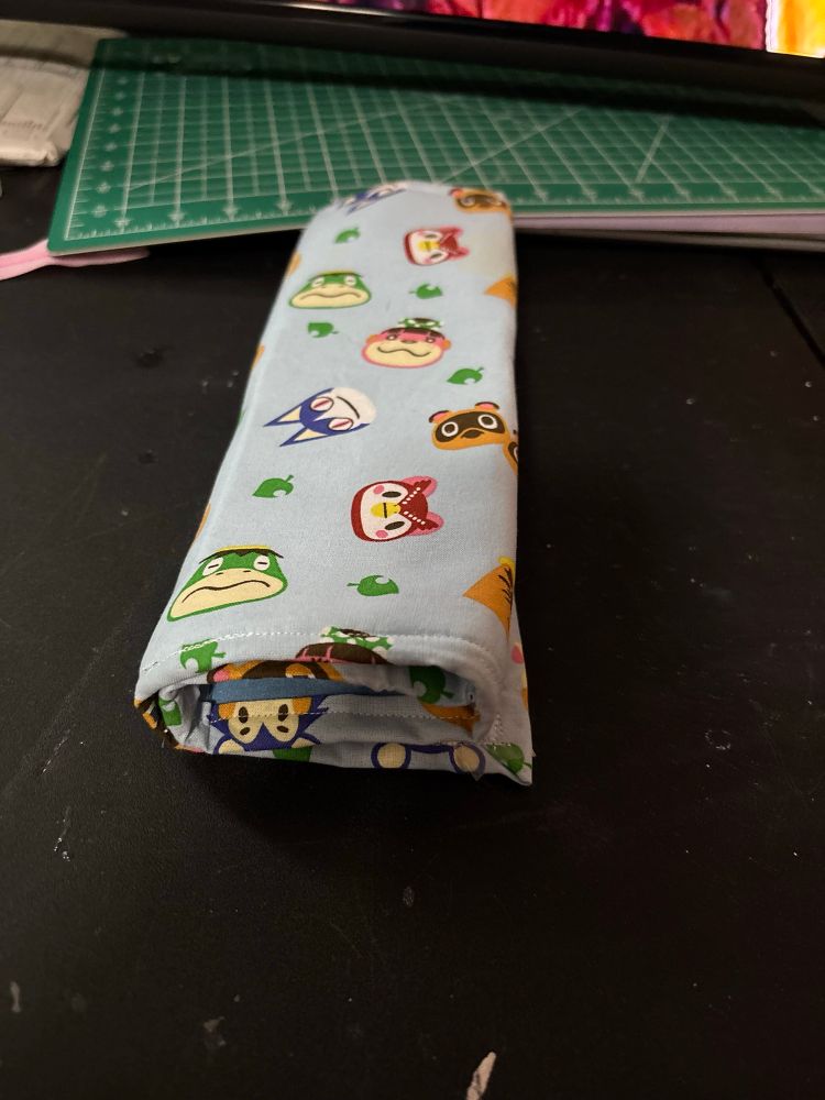 A folded up organizer with animal crossing characters in a light blue background. 