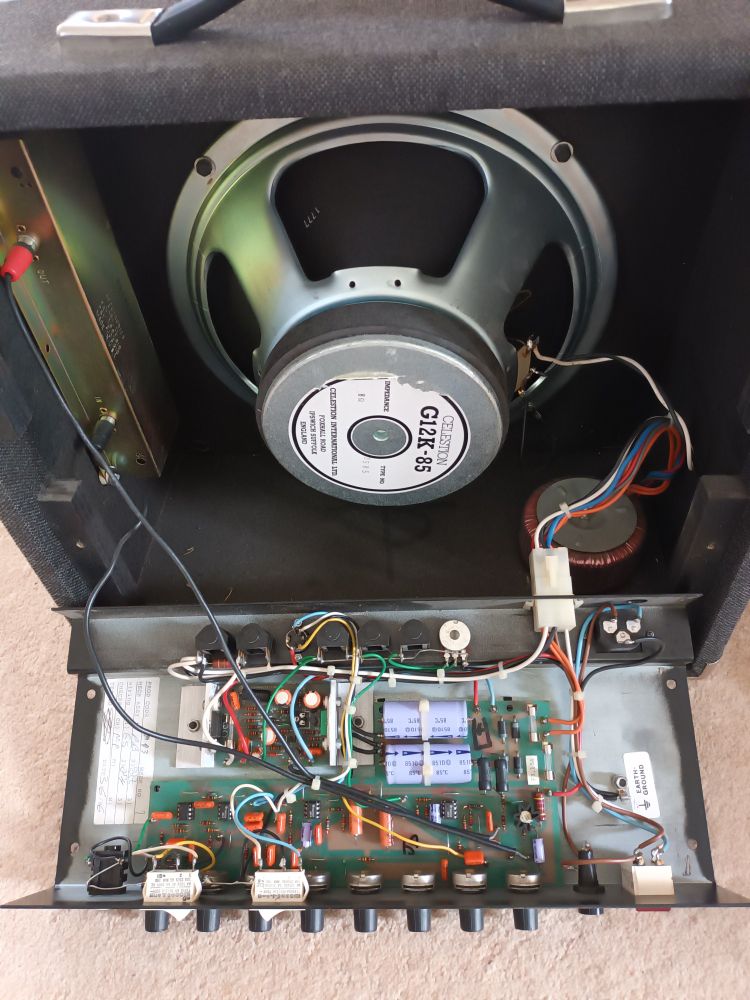 Inside view of a disassembled Sessionette 75 guitar amplifier that required some minor surgery to recover from a temporarily lost voice. Good view of the Celestion speaker and spring reverb housed in the metal box to left of the photograph. Basingstoke may not be the centre of the musical universe, but gave us  Session amplifiers and Tanita Tikaram...