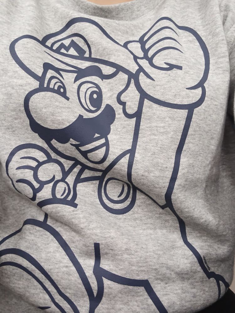 A gray sweater with a print of Mario from Super Mario franchise on it