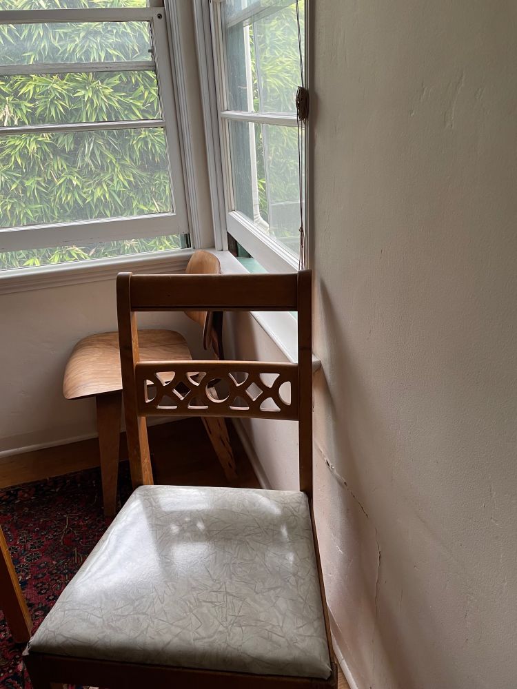 Two chairs near a window. 