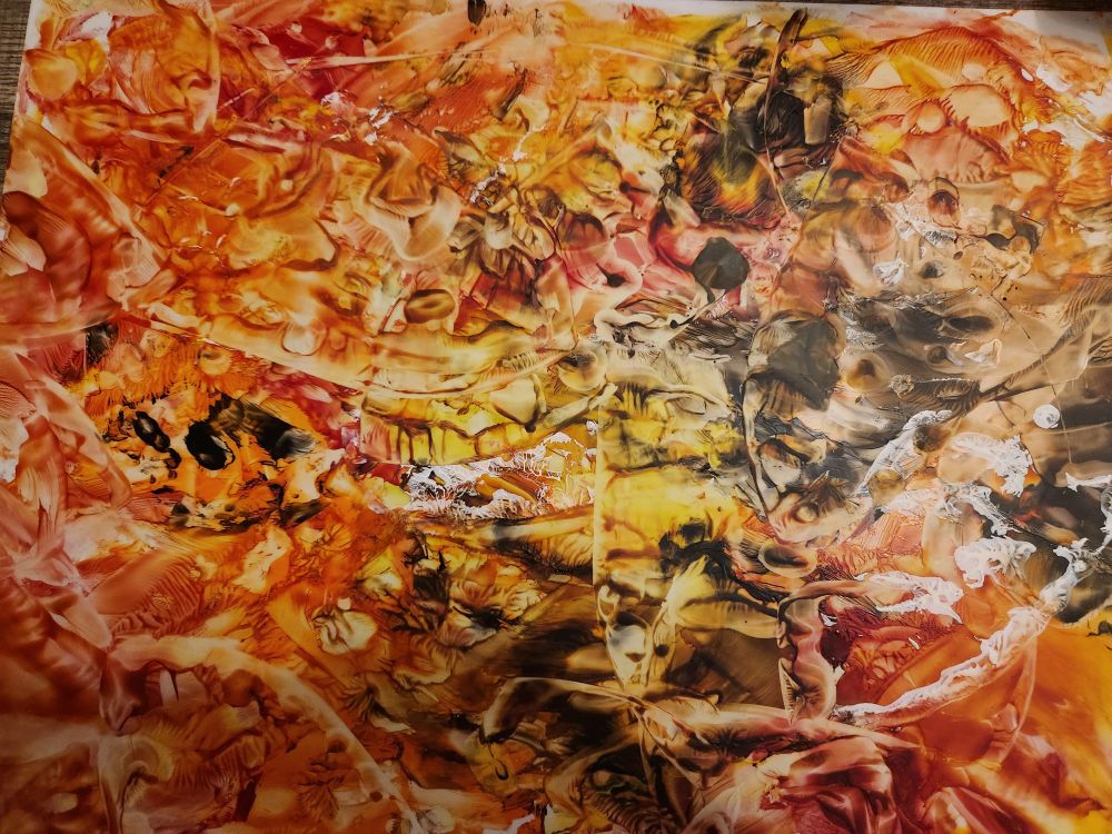 Abstract art piece, wax on lupo, in shades of yellow, orange, red, black and white.