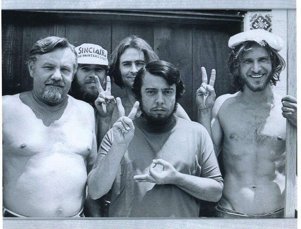 Group picture of a young and scruffy Harrison Ford with Sergio Mendes and other men building Sergio Mendes’ home recording studio. 