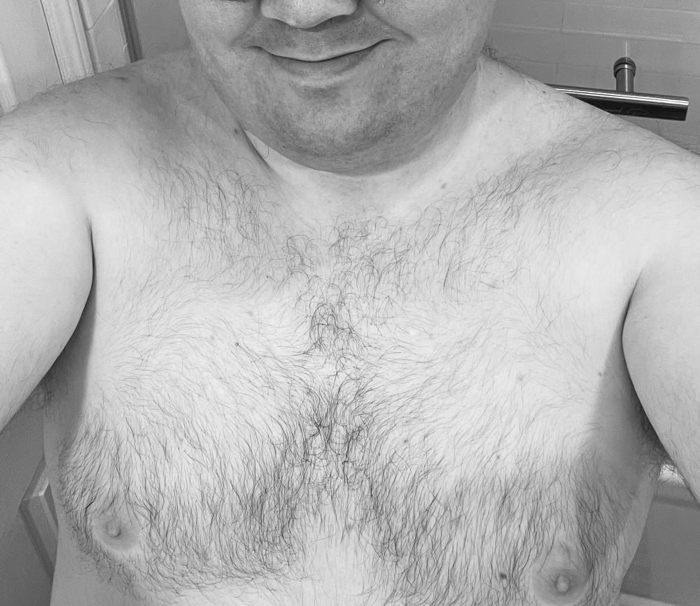 A black-&-white selfie of a shirtless Whisper, now freshly-shaved and with a smooth, clean face.