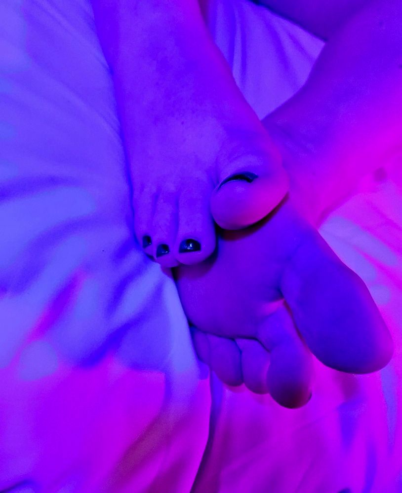Two beautiful feet with colorful lighting.
