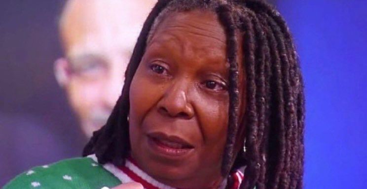 Whoopi Goldberg (brownskin black woman with dreadlocks) looking shocked distressed