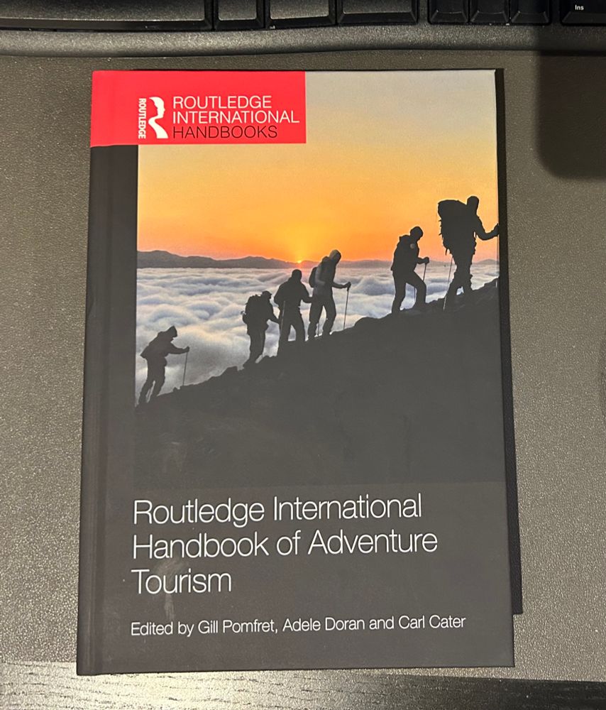 A copy of the book “Routledge International Handbook of Adventure Tourism” edited by Gill Pomfret, Adele Doran and Carl Cater