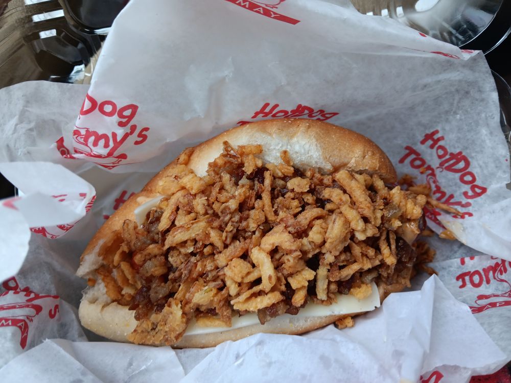 A photo of a freshly unwrapped Hotdog Tommy's hotdog.