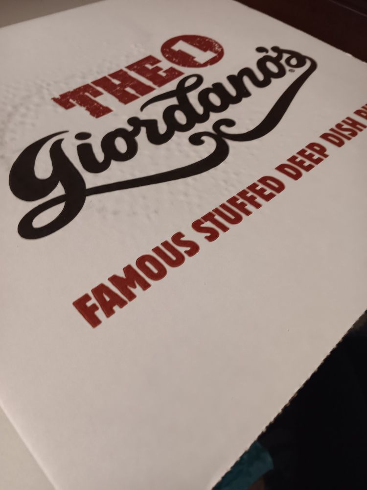 A Giordano's pizza box. Inside is a delicious pizza that many will not hesitate to tell you their full, unedited (often unwarranted) opinion of.