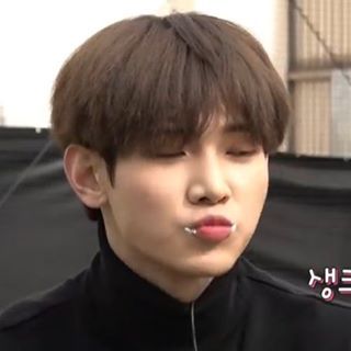 Kang Yeosang (ATEEZ) making a kissy face with some white cream smudged on his lips