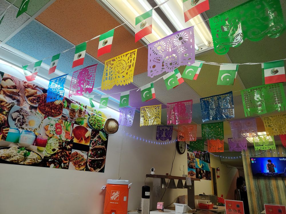 Inside Mexi-Pak restaurant with Mexico and Pakistan flags hanging from the ceiling 