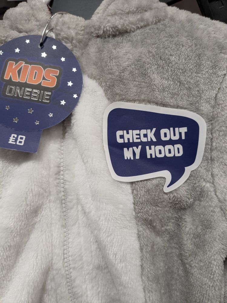 Child's onesie for sale with a sticker on it reading 'check out my hood'