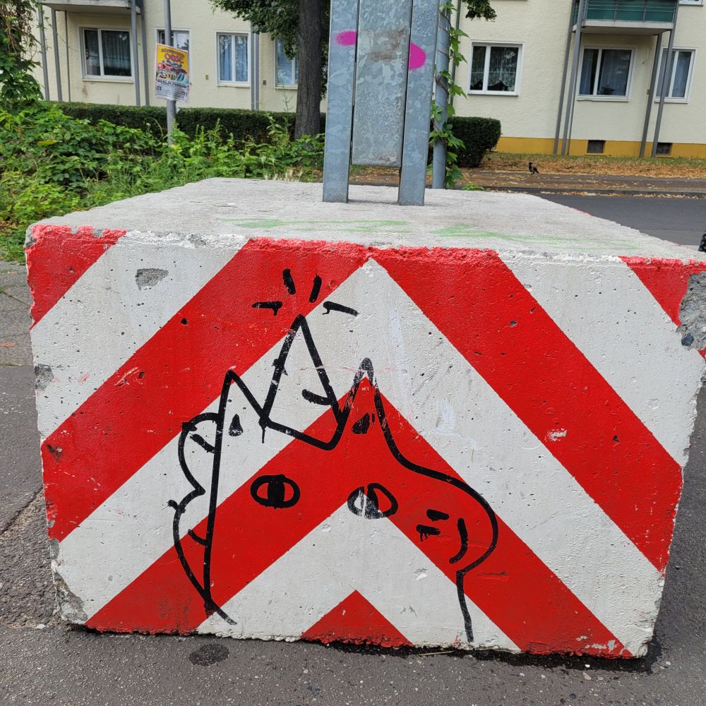 A graffiti of a cute and derpy unicorn on a construction site