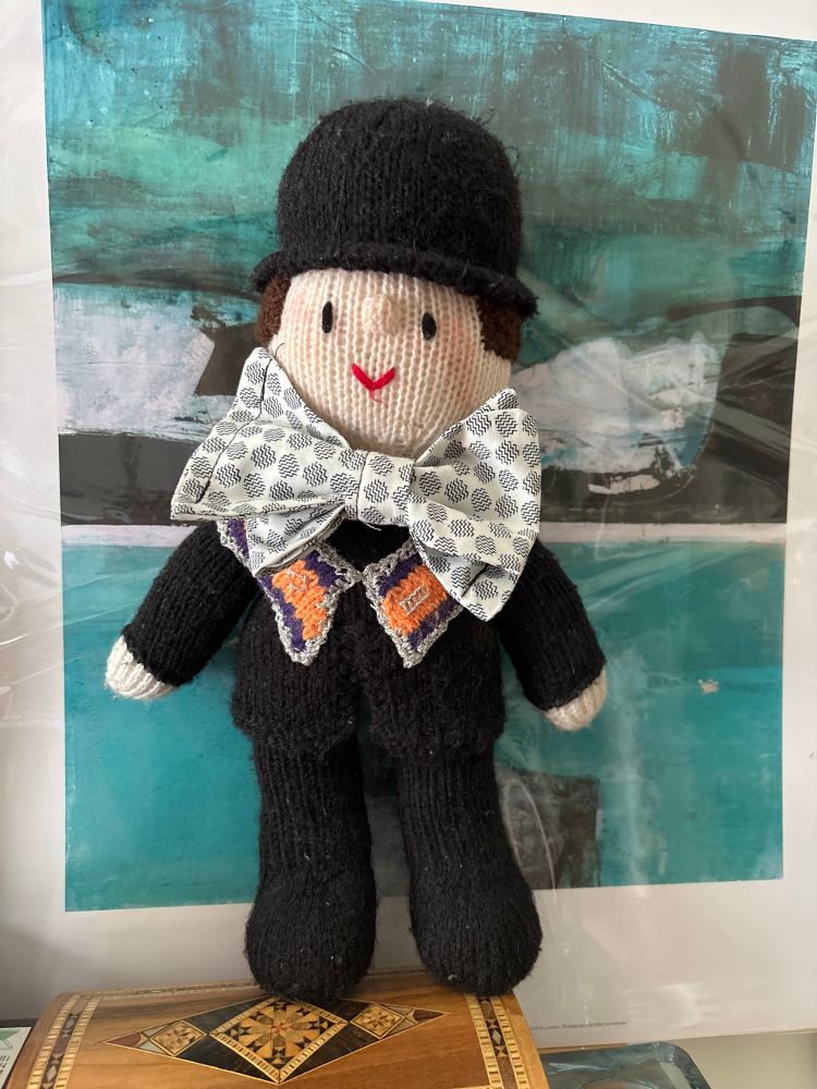 Photograph of a hand-knitted member of the Ulster Orange Order in full marching regalia