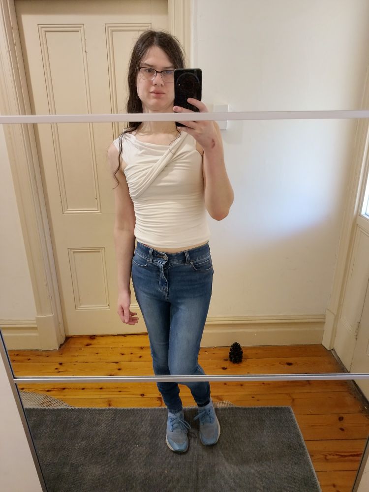 mirror selfie, blue jeans and a white sleeveless top,, pretty boring sorry im just very pretty