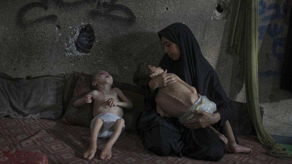 GAZA CITY, Gaza Strip (AP) — In some tents and shelters in northern Gaza, emaciated children are held in their parents' arms. Their tiny arms and legs dangle limp.