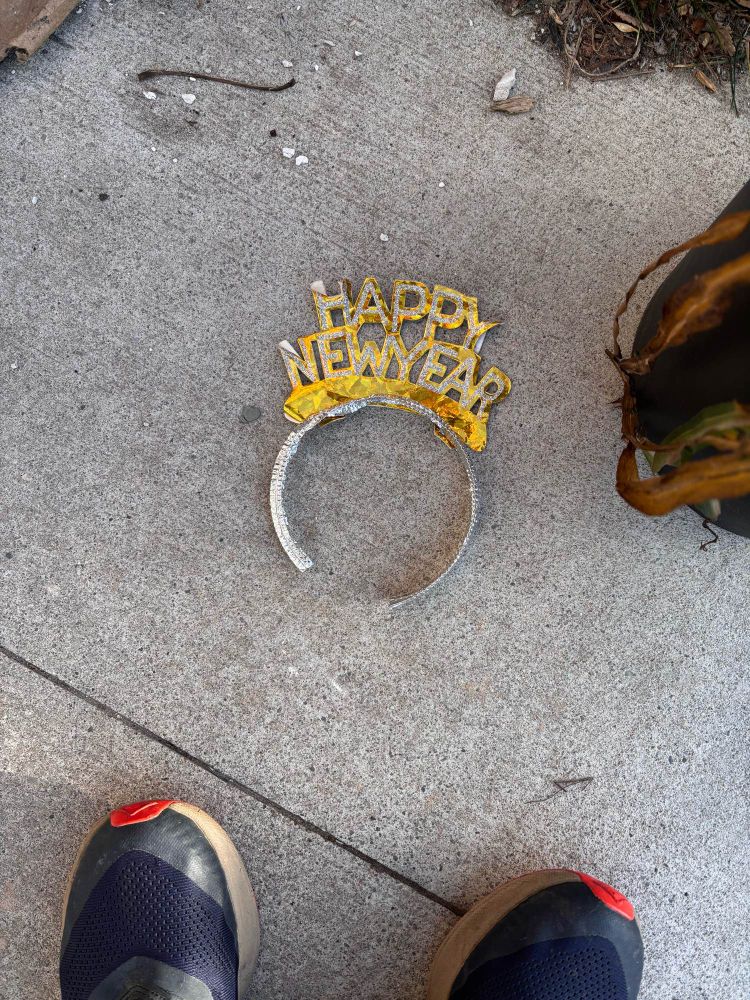 Snapshot of a “happy new year” tiara lying on the pavement the morning after the night before 
