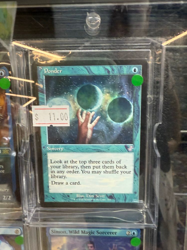 The magic card ponder which features a hand reaching for an orb