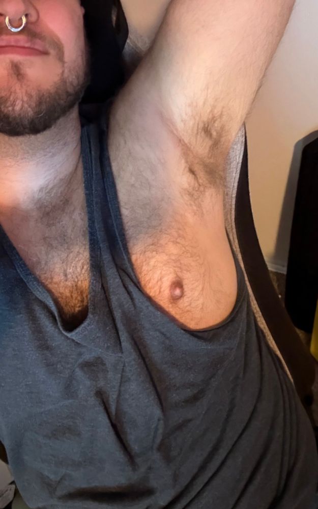 A selfie where I’ve got one arm raised and my nipple pulled through the arm of my tank top