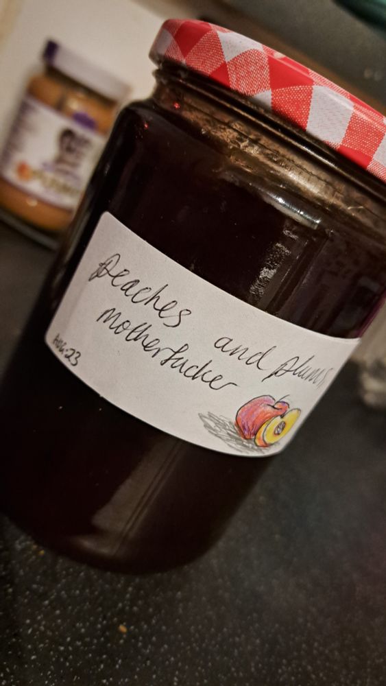 a jar of jam with the label "Peaches and Plus, motherfucker" next to a picture of a peach.