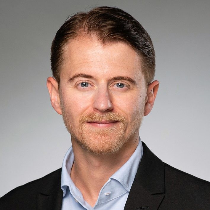 Portrait of Jordan Bisset who is now Senior Research Fellow at the Max Planck Institute for Innovation and Competition