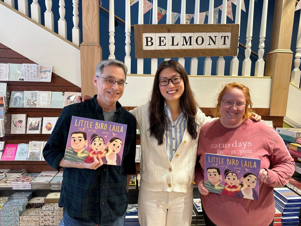 Photo of author Kelly Yang with Chris Abouzeid and Tildy Lutts from Belmont Books, holding up Kelly's new picture book LITTLE BIRD LAILA