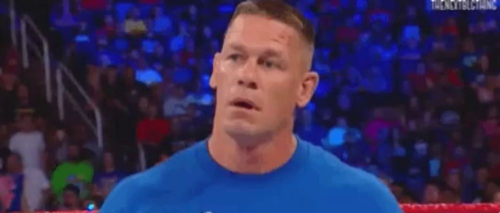 a close up of a man 's face with his mouth open in a wrestling match .