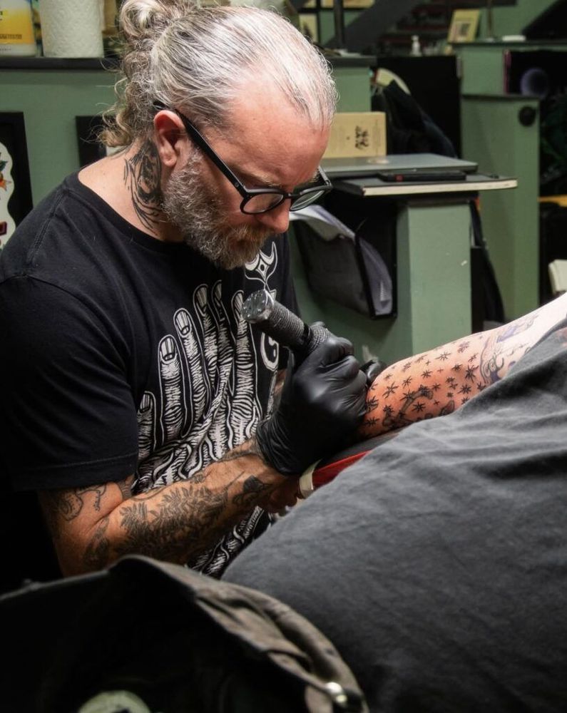 Aaron Turner of Sumac, with tattoo needle in hand. 