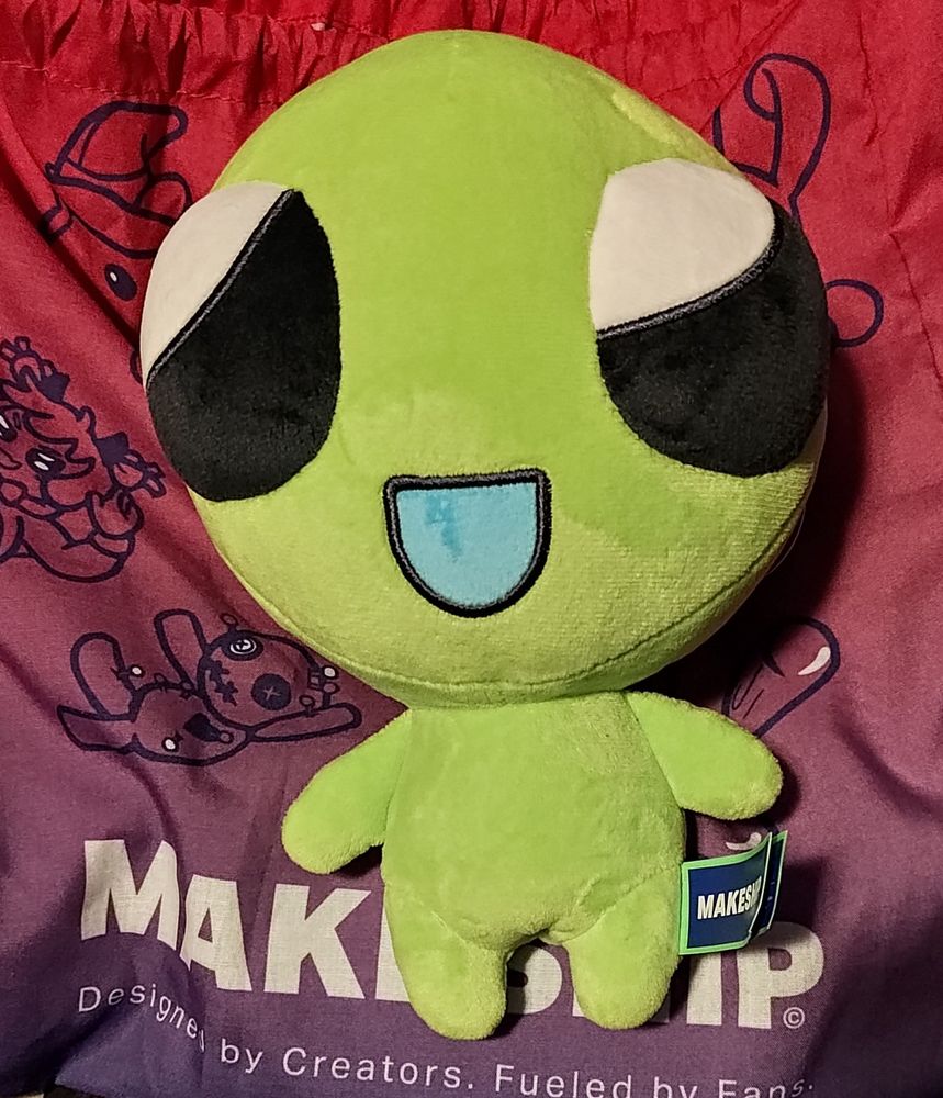 Photo of a makeship plushie of Flug, a smiling little green alien