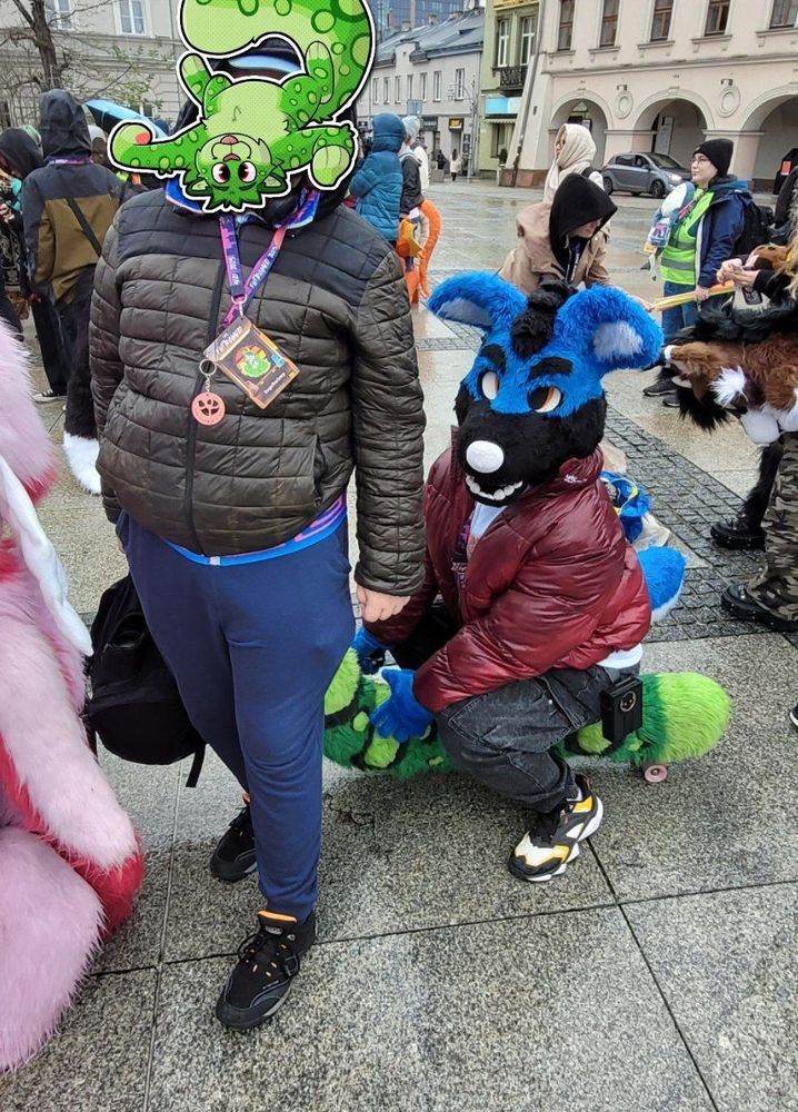 a picture of snep with his tail and a different fursuiter sitting on the tail