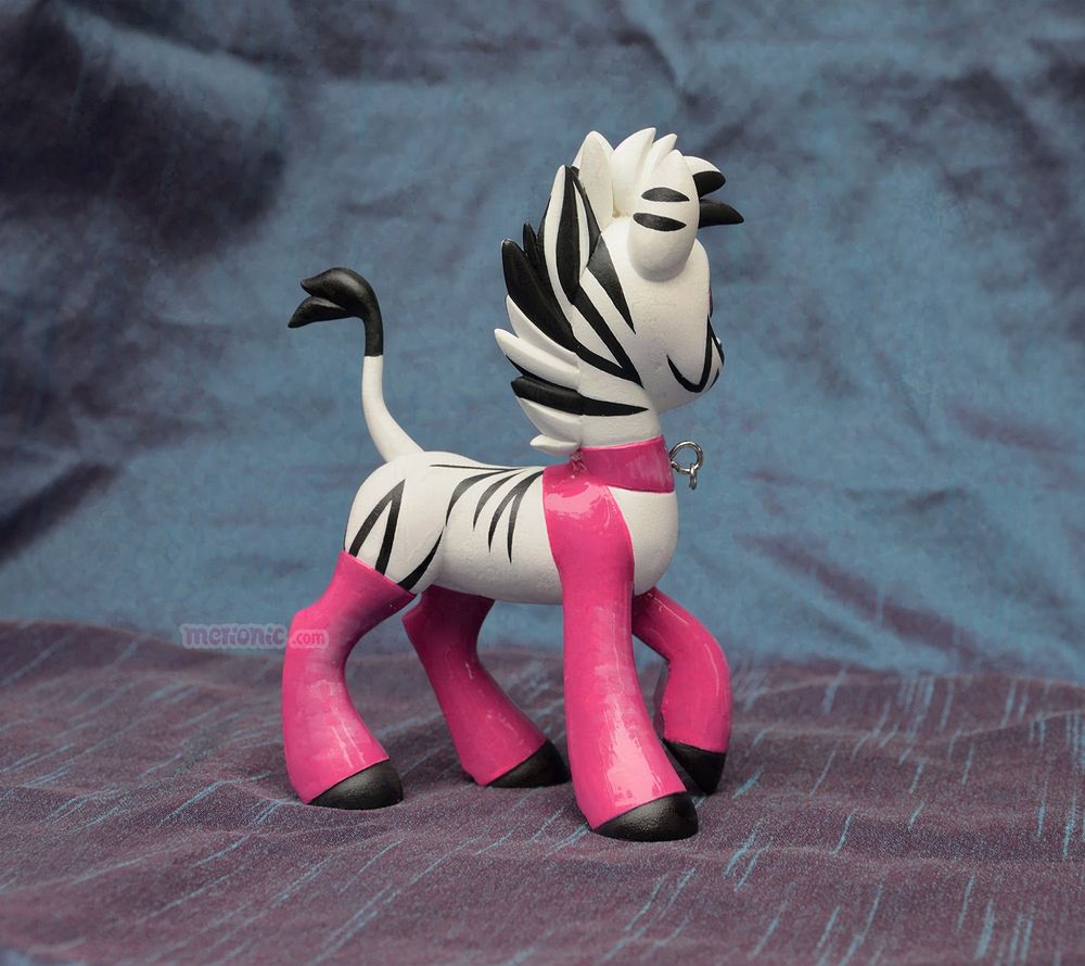 A photo of a handmade zebra figurine.
