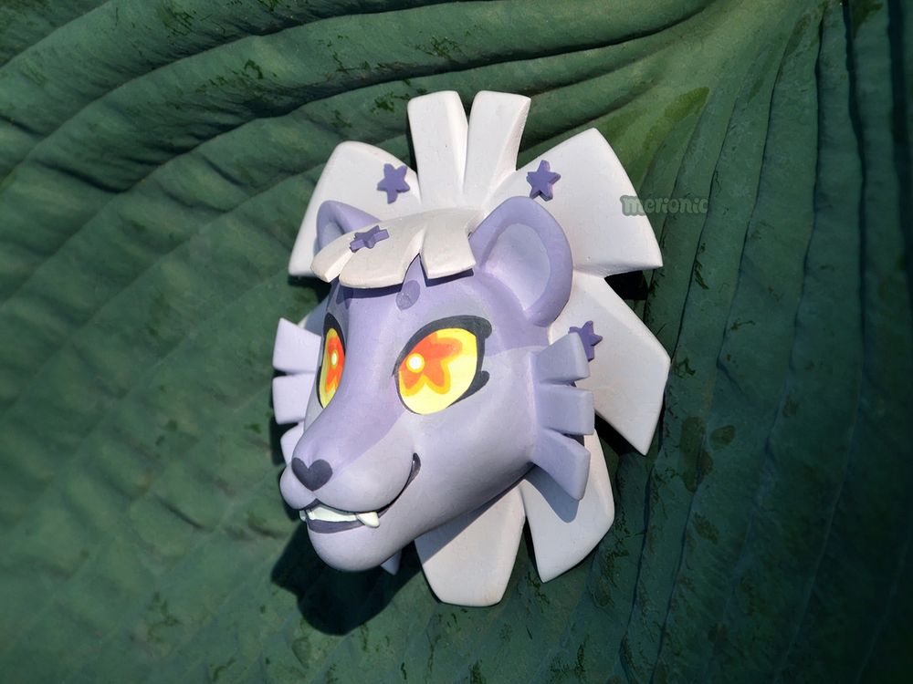 A handmade fridge magnet. Made of resin and epoxy putty, painted with acrylics.