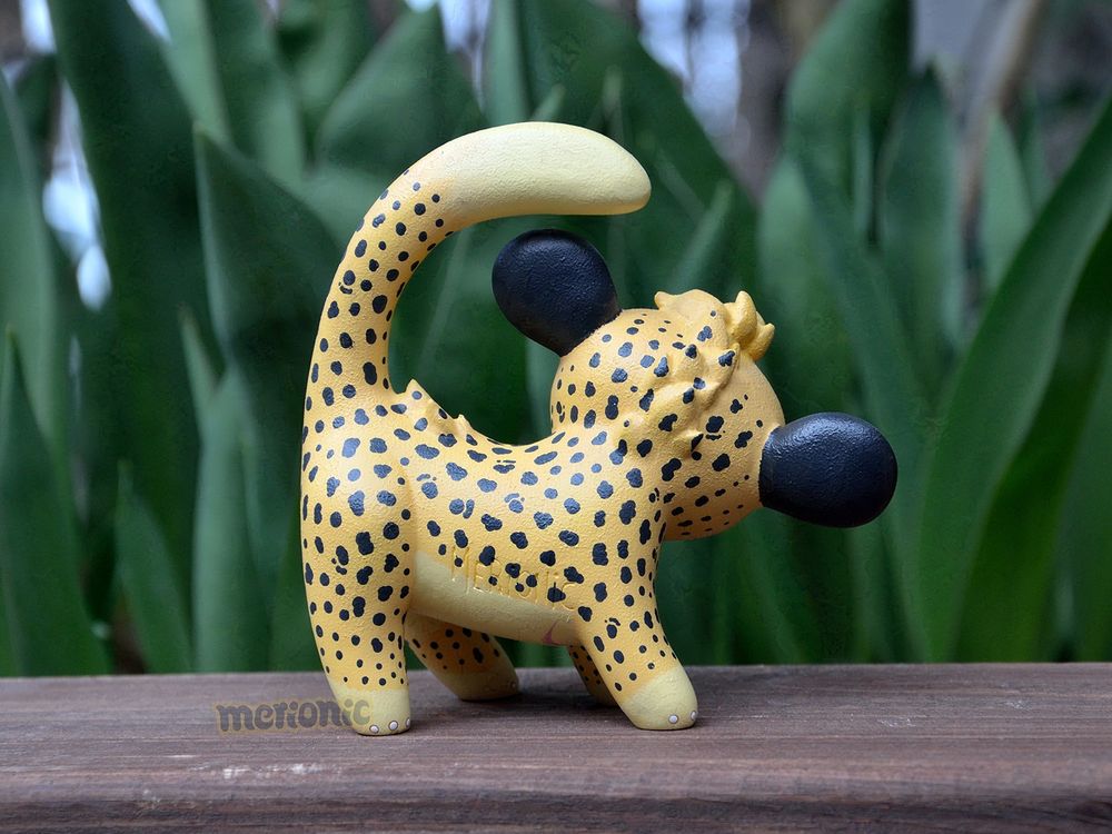A handmade figurine of a cheetah character.