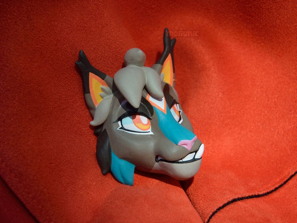 A handmade fridge magnet. It's a head of a lynx character.