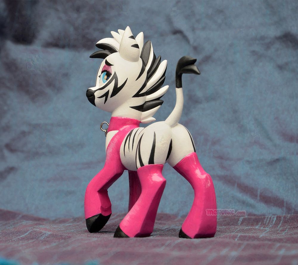 A photo of a handmade zebra figurine.