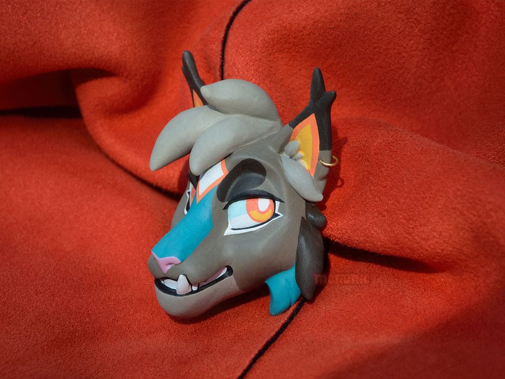 A handmade fridge magnet. It's a head of a lynx character.