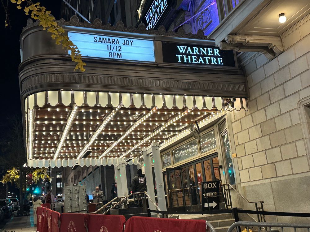 A sign shines at night with the words “Samara Joy, 11/12, 8pm” at the Warner Theatre 