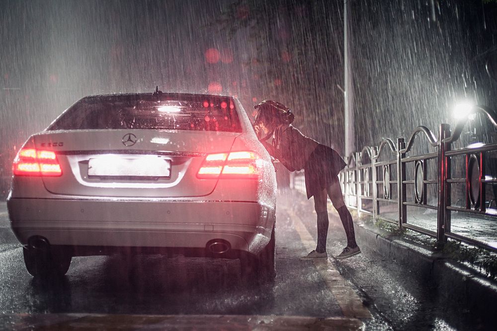 Screenshot of the film 'The truth beneath' by Lee Kyoung Mi (2016). A schoolgirl is leaning into a car at night when it is raining.