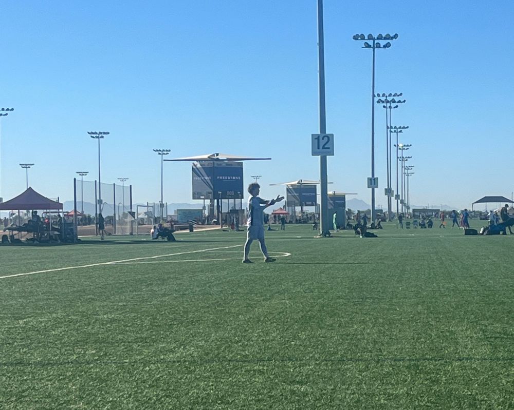First half Alexandria Soccer Association 2010 MLSNext goalie in lavender uniform with arms waved pushing the lines up. Clean sheet for him. 