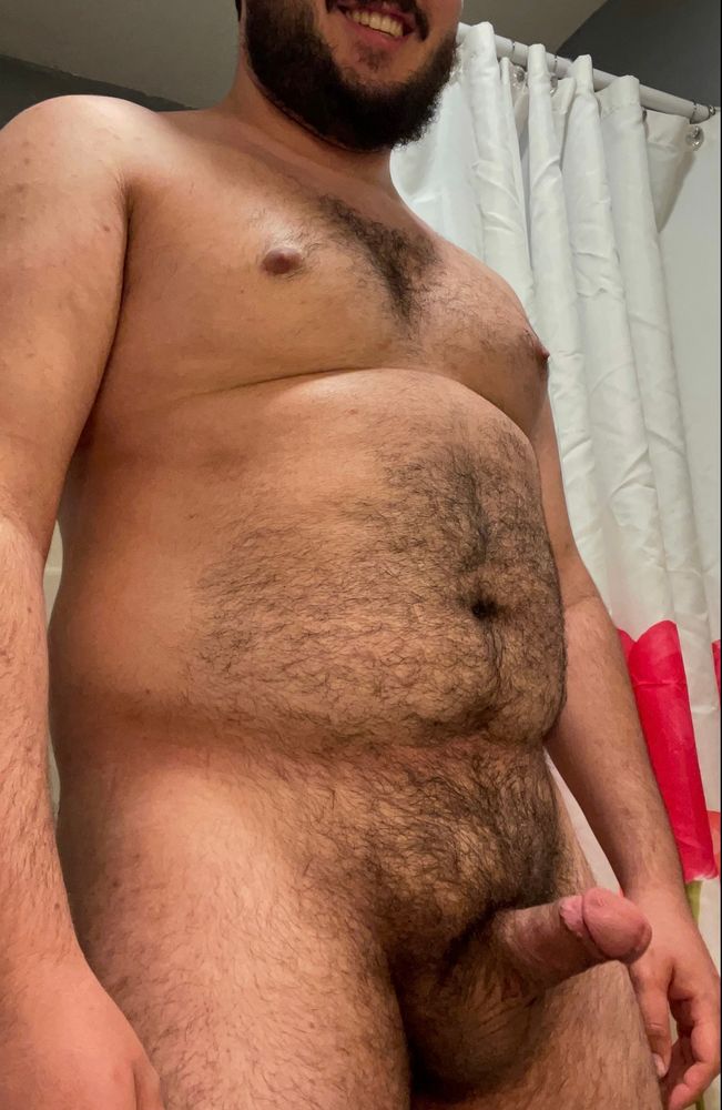 Hairy man smiling with his hard cock ready to be sucked  