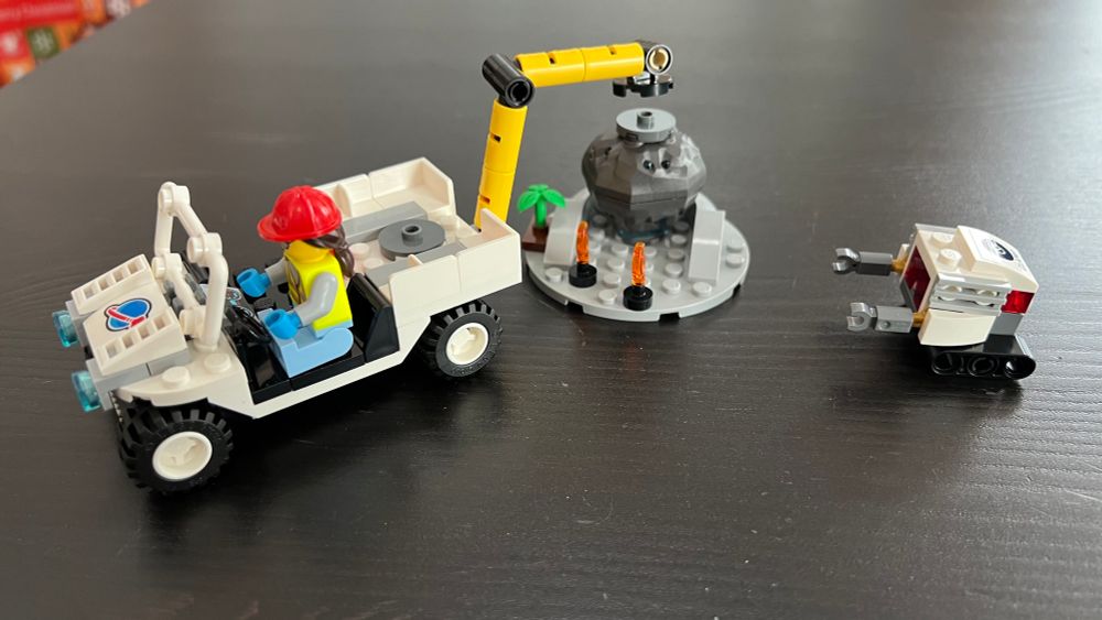 Part of the LEGO “Rocket Launch Center” set showing the truck, lunar sample, and little robot. 