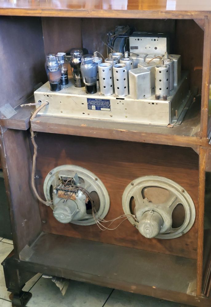 The back side of a 1933 Interocean 530 radio showing the chassis, tubes and two speakers.
