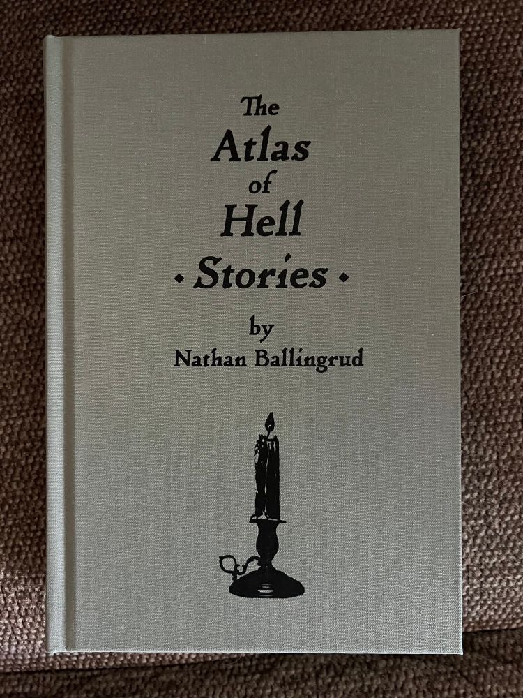 Midworld Press edition of The Atlas Of Hell by Nathan Ballingrud without its dust jacket. Title, author, and a candelabra underneath. 