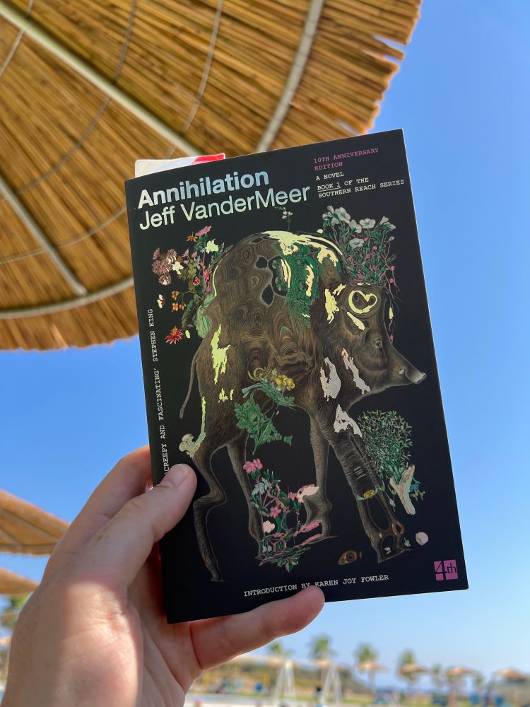Annihilation, by VanderMeer, against a blue sky and poolside parasols 
