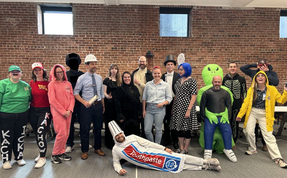 group photo at a halloween party. i am there as the architect stock photo in a shot with other costumed people including but not limited to: a tube of toothpaste, a lichtenstein painting, rosie the riveter, and edward gorey