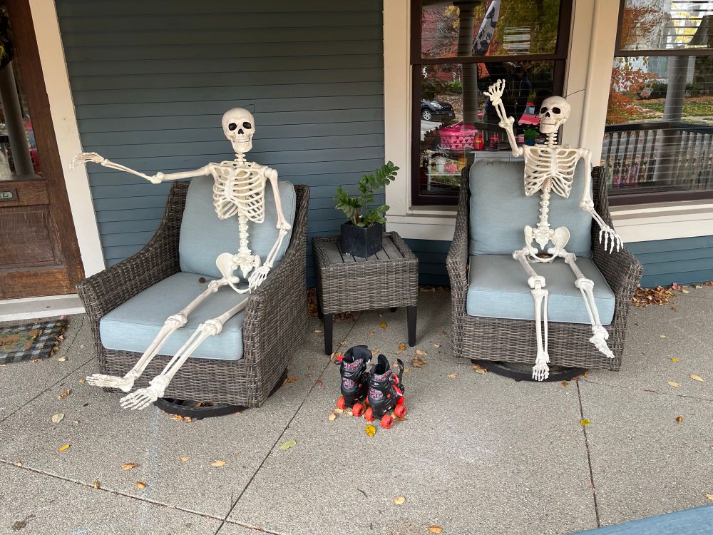 skeletons on my porch waiting to be put away in unfortunate Nazi salute poses