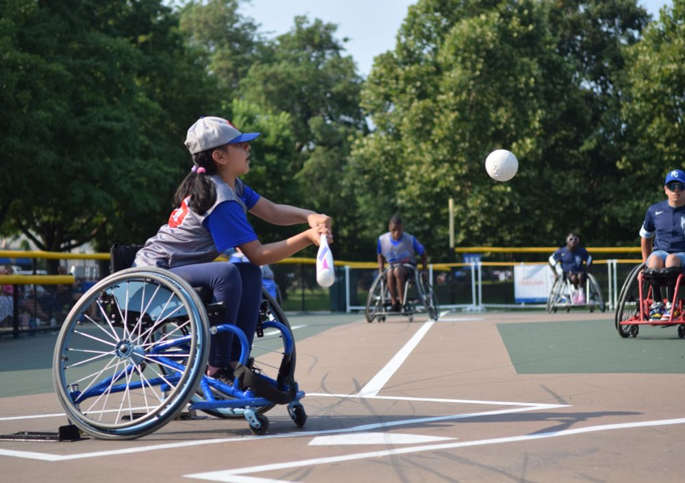 Sarai, a prep player on the Chicago Junior Wheelchair Cubs donning a grey jersey with blue sleeves and red lettering, takes a swing during the 2025 Wheelchair Softball Junior World Series at California Park's paved baseball diamond on Saturday.