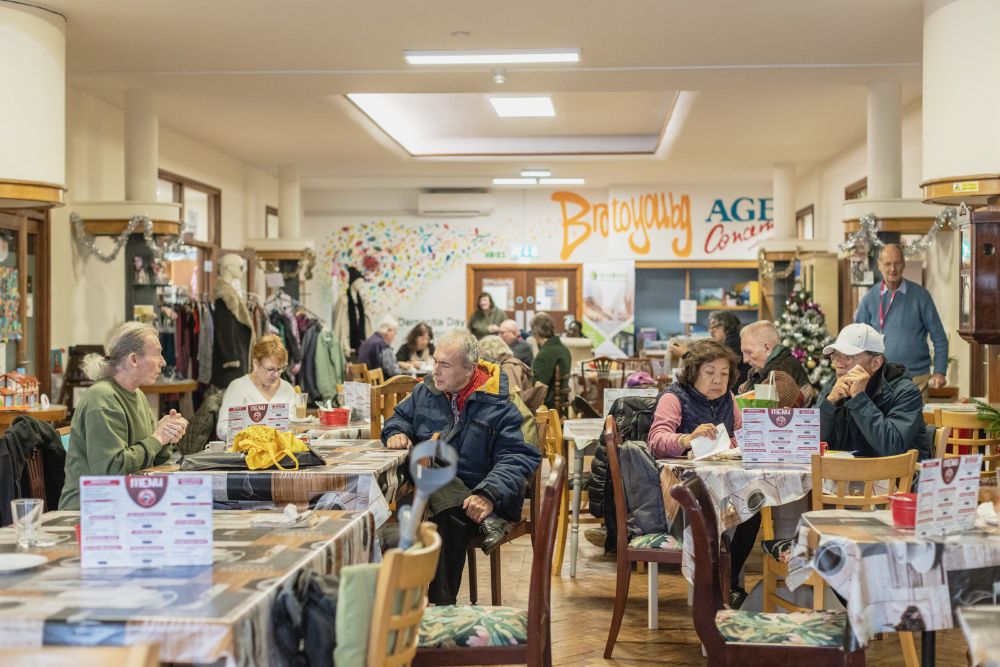 The cafe in the Haven Community Hub, Southend-on-Sea. There are people chatting at their tables and the room is decorated for Christmas.